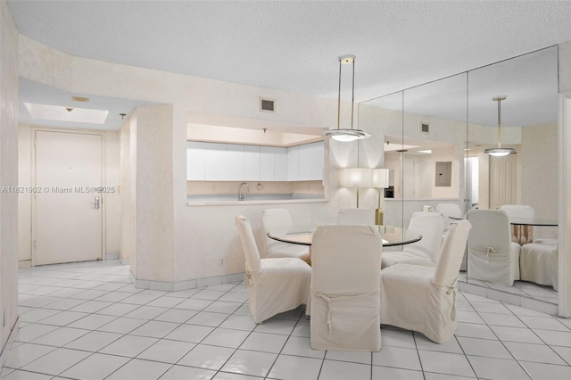 9455 Collins Ave Unit 305, Surfside, FL 33154 - dining room featuring electric panel, light tile patterned flooring, and a textured ceiling