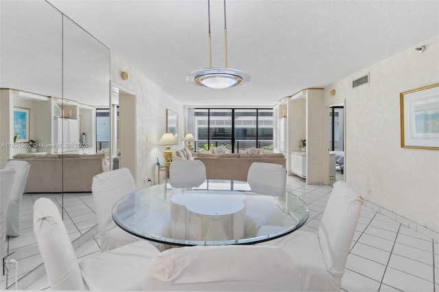 9455 Collins Ave Unit 305, Surfside, FL 33154 - dining room featuring light tile patterned flooring and a textured ceiling