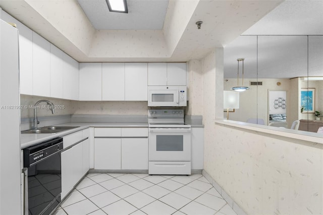 9455 Collins Ave Unit 305, Surfside, FL 33154 - kitchen with white appliances, light countertops, white cabinets, and hanging light fixtures