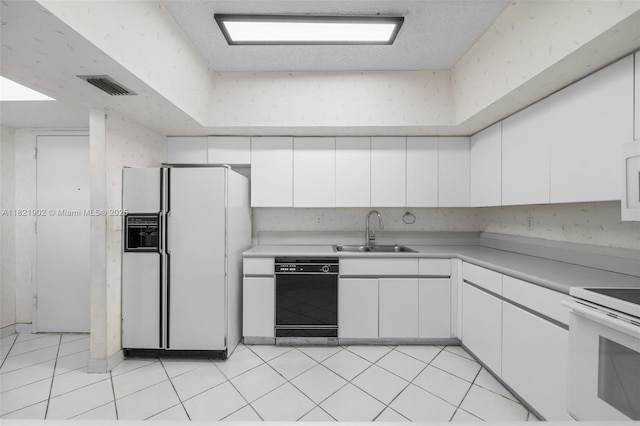 9455 Collins Ave Unit 305, Surfside, FL 33154 - kitchen with white appliances, white cabinetry, light countertops, and light tile patterned floors