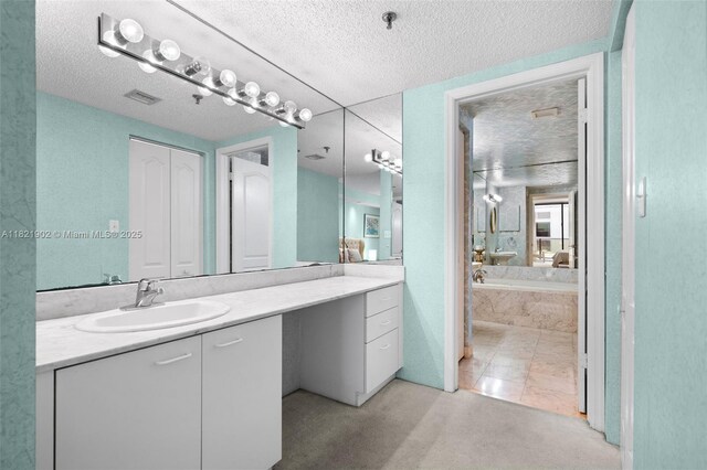 9455 Collins Ave Unit 305, Surfside, FL 33154 - bathroom featuring a textured ceiling, vanity, and a bath