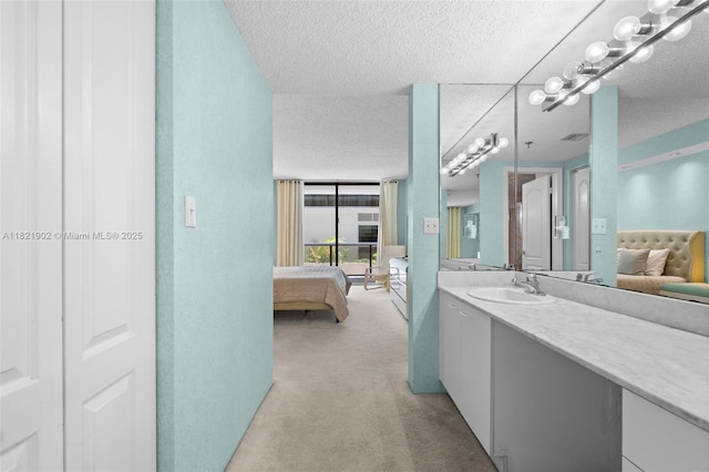 9455 Collins Ave Unit 305, Surfside, FL 33154 - bathroom with connected bathroom, vanity, and a textured ceiling