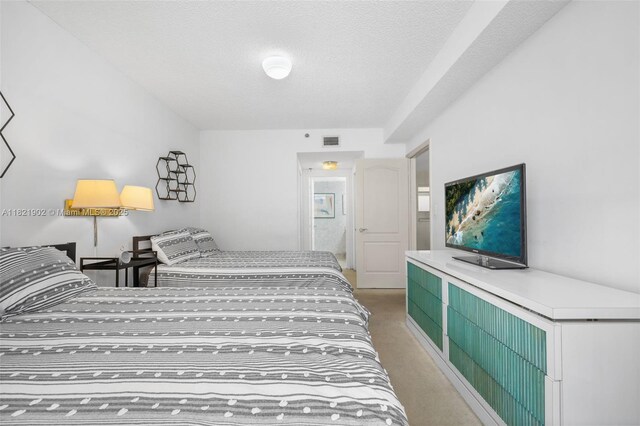 9455 Collins Ave Unit 305, Surfside, FL 33154 - bedroom with light colored carpet and a textured ceiling