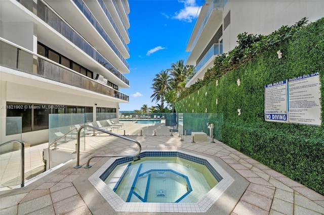 9455 Collins Ave Unit 305, Surfside, FL 33154 - community pool featuring a hot tub and a patio area