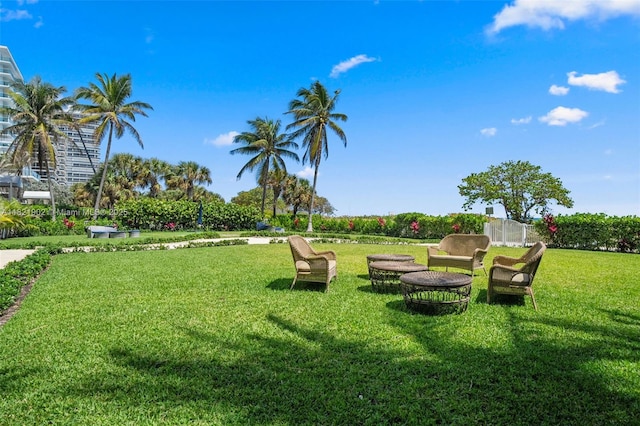 9455 Collins Ave Unit 305, Surfside, FL 33154 - view of green lawn featuring an outdoor fire pit