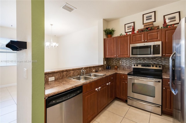 2935 SE 1st Dr Unit 21, Homestead, FL 33033 - kitchen featuring appliances with stainless steel finishes, light tile patterned flooring, tasteful backsplash, and a chandelier