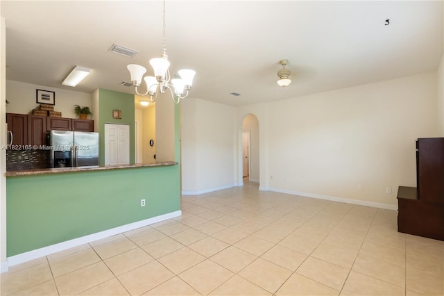 2935 SE 1st Dr Unit 21, Homestead, FL 33033 - kitchen featuring stainless steel refrigerator with ice dispenser, arched walkways, a chandelier, light tile patterned floors, and decorative light fixtures