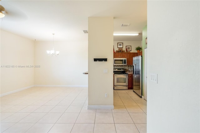 2935 SE 1st Dr Unit 21, Homestead, FL 33033 - spare room with light tile patterned flooring and a chandelier