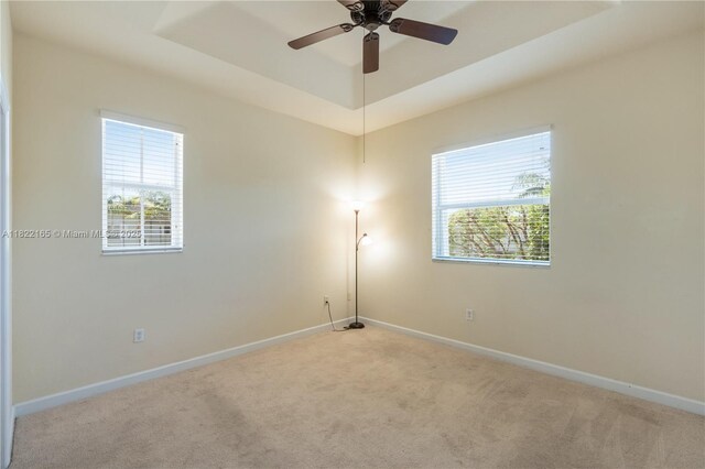 2935 SE 1st Dr Unit 21, Homestead, FL 33033 - unfurnished room featuring carpet flooring, plenty of natural light, a raised ceiling, and a ceiling fan