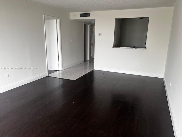 498 NW 165th St Rd Unit D303, Miami, FL 33169 - spare room with wood finished floors and a textured ceiling