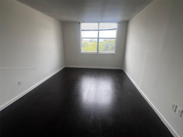498 NW 165th St Rd Unit D303, Miami, FL 33169 - empty room with a textured ceiling and dark wood finished floors