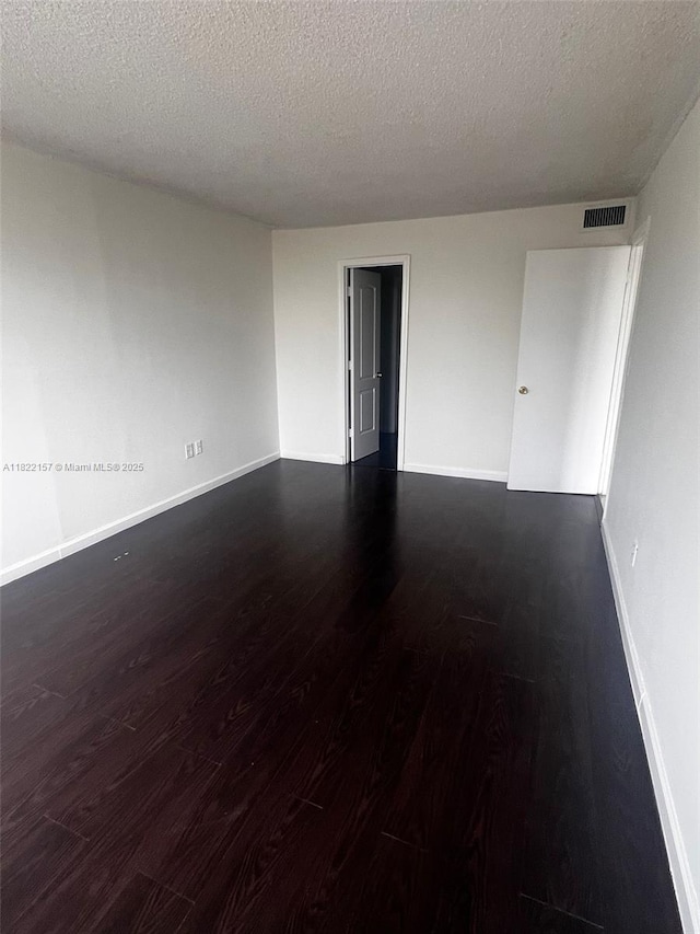 498 NW 165th St Rd Unit D303, Miami, FL 33169 - spare room with wood finished floors and a textured ceiling