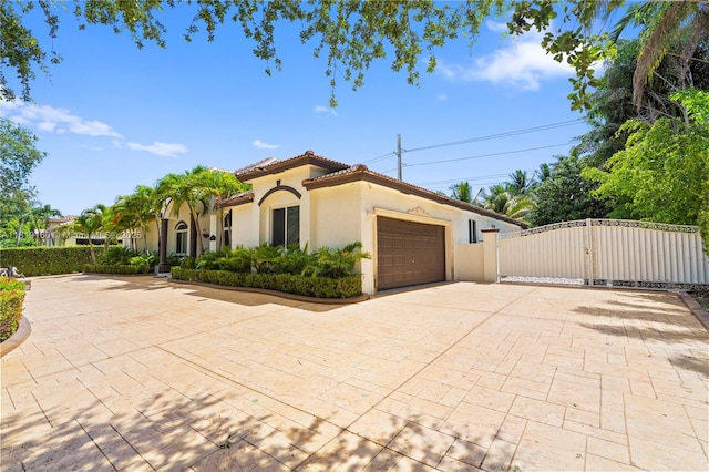 16601 SW 87th Ct, Palmetto Bay, FL 33157 - view of front of house with a gate, stucco siding, decorative driveway, a garage, and a tile roof