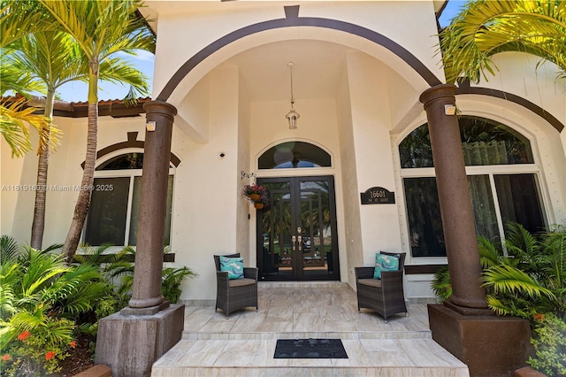 16601 SW 87th Ct, Palmetto Bay, FL 33157 - view of exterior entry featuring french doors and stucco siding