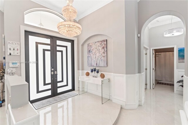 16601 SW 87th Ct, Palmetto Bay, FL 33157 - foyer with ornamental molding, a chandelier, and arched walkways