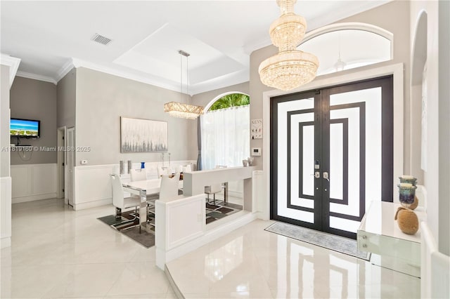 16601 SW 87th Ct, Palmetto Bay, FL 33157 - tiled entryway with a chandelier, ornamental molding, and a wainscoted wall