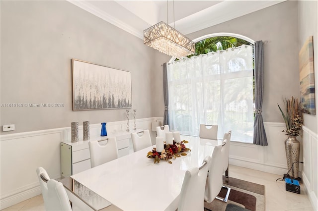 16601 SW 87th Ct, Palmetto Bay, FL 33157 - dining room featuring wainscoting, a chandelier, light tile patterned floors, a decorative wall, and ornamental molding