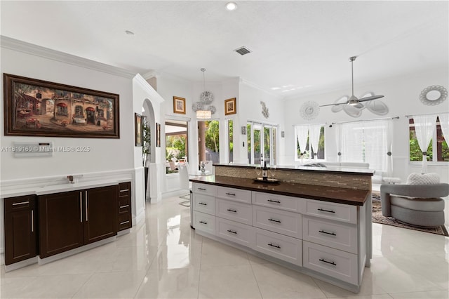 16601 SW 87th Ct, Palmetto Bay, FL 33157 - kitchen featuring ornamental molding, a ceiling fan, arched walkways, decorative light fixtures, and open floor plan