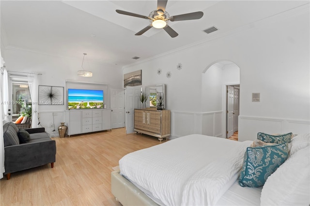 16601 SW 87th Ct, Palmetto Bay, FL 33157 - bedroom with light wood-type flooring, ornamental molding, arched walkways, a ceiling fan, and wainscoting