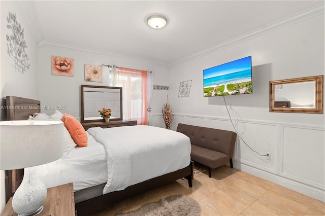 16601 SW 87th Ct, Palmetto Bay, FL 33157 - bedroom with crown molding, light tile patterned floors, wainscoting, and a decorative wall
