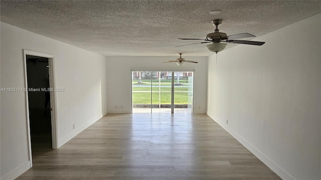 608 NE 2nd St Unit 133, Dania Beach, FL 33004 - unfurnished room featuring wood finished floors, a textured ceiling, and a ceiling fan