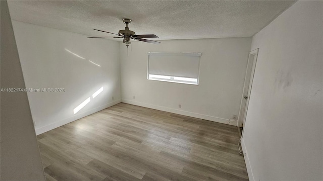 608 NE 2nd St Unit 133, Dania Beach, FL 33004 - empty room featuring a textured ceiling, wood finished floors, and a ceiling fan