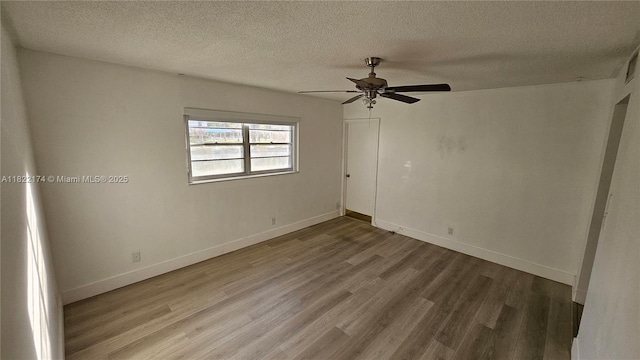 608 NE 2nd St Unit 133, Dania Beach, FL 33004 - empty room with wood finished floors, a ceiling fan, and a textured ceiling