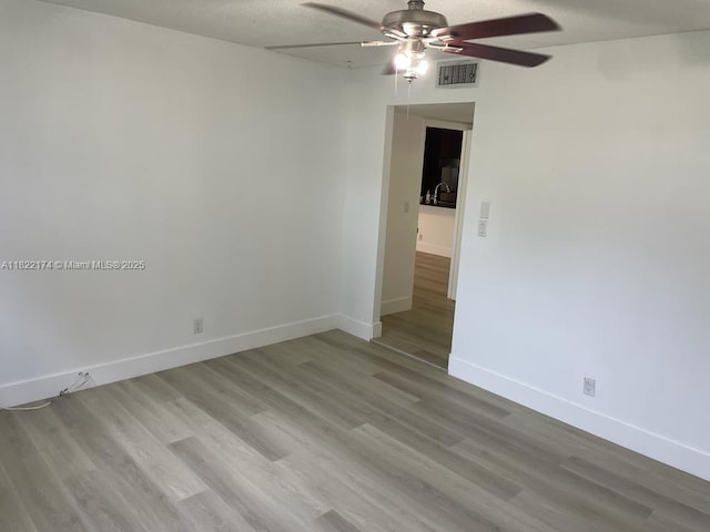 608 NE 2nd St Unit 133, Dania Beach, FL 33004 - spare room featuring a ceiling fan and wood finished floors