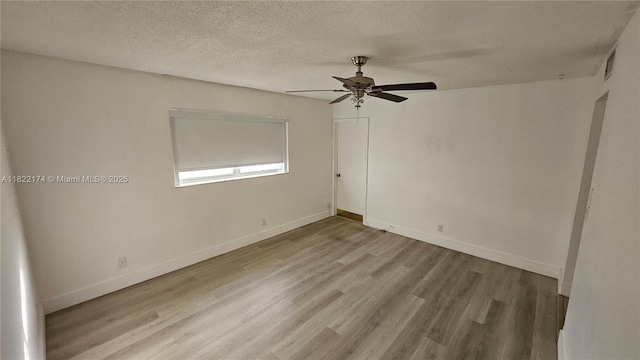 608 NE 2nd St Unit 133, Dania Beach, FL 33004 - spare room with wood finished floors, a ceiling fan, and a textured ceiling