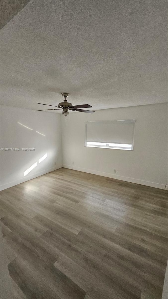 608 NE 2nd St Unit 133, Dania Beach, FL 33004 - empty room featuring wood finished floors, a ceiling fan, and a textured ceiling