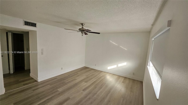 608 NE 2nd St Unit 133, Dania Beach, FL 33004 - empty room featuring wood finished floors, a textured ceiling, and ceiling fan