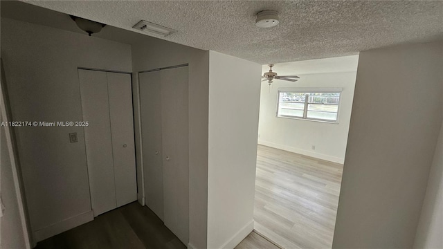 608 NE 2nd St Unit 133, Dania Beach, FL 33004 - corridor featuring a textured ceiling and wood finished floors