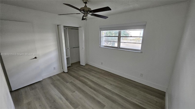 608 NE 2nd St Unit 133, Dania Beach, FL 33004 - unfurnished bedroom with wood finished floors, a closet, and a ceiling fan