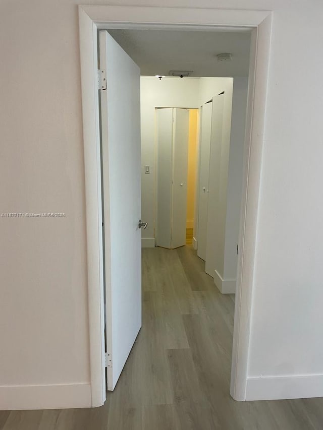 608 NE 2nd St Unit 133, Dania Beach, FL 33004 - hall with baseboards and light wood finished floors