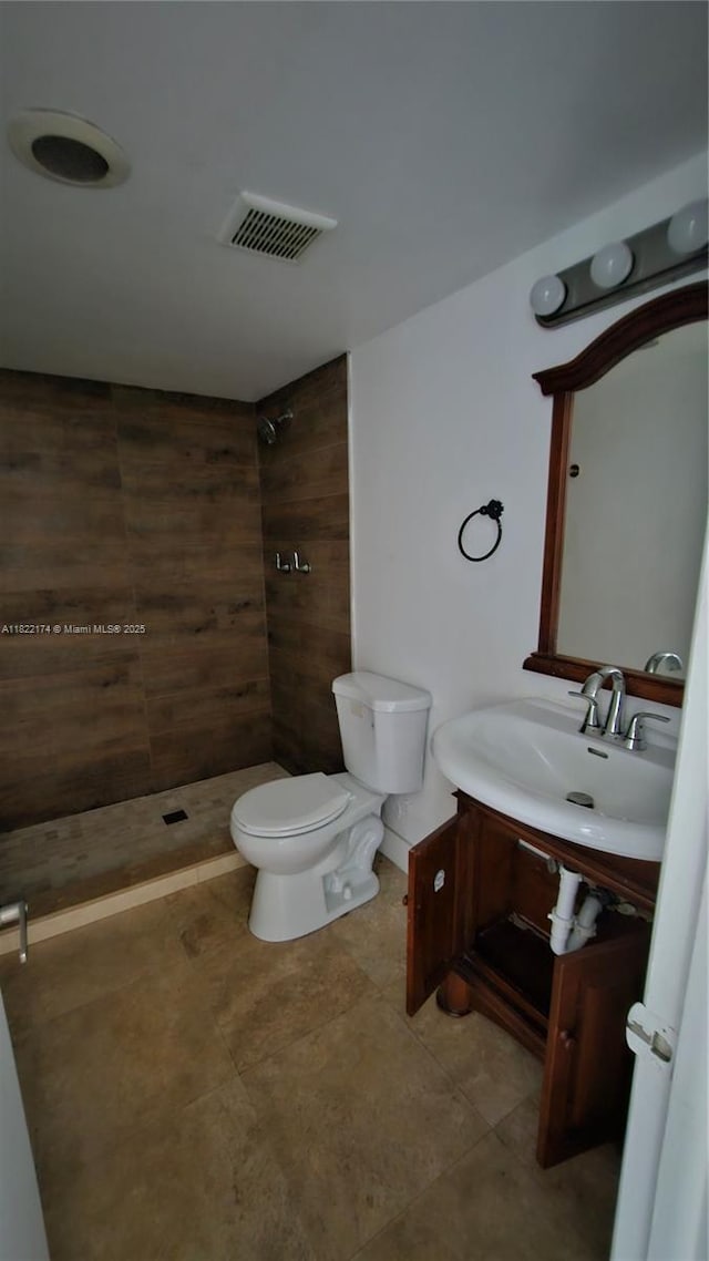 608 NE 2nd St Unit 133, Dania Beach, FL 33004 - bathroom with vanity, tiled shower, and tile patterned flooring