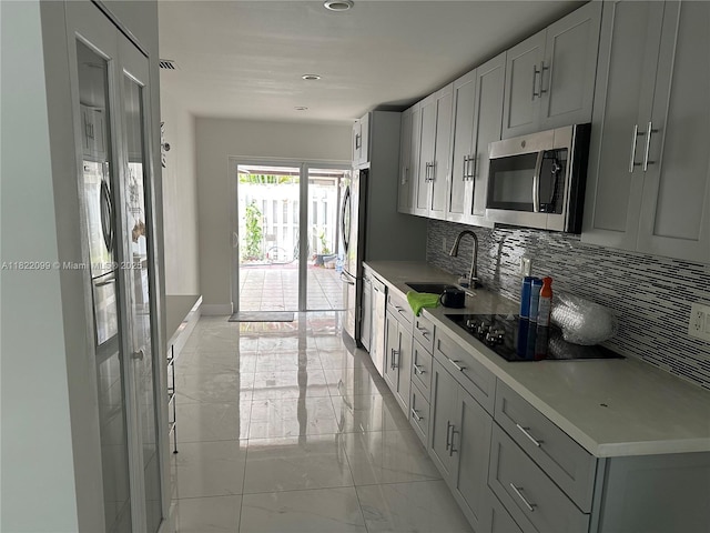 14944 SW 88th Ter, Miami, FL 33196 - kitchen with stainless steel appliances, light marble finish floors, tasteful backsplash, light countertops, and recessed lighting