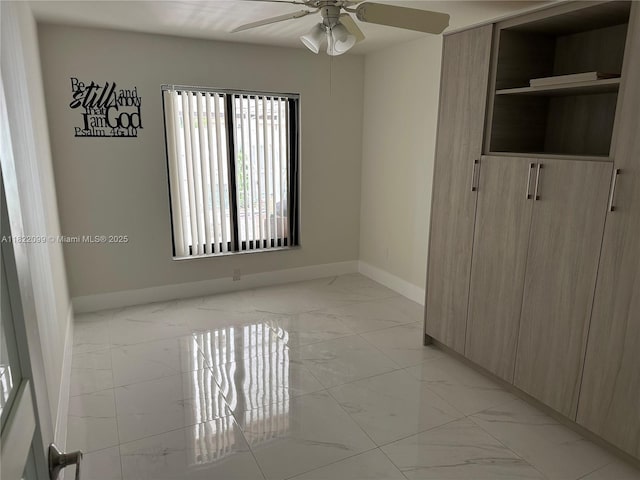 14944 SW 88th Ter, Miami, FL 33196 - empty room with light marble finish floors and a ceiling fan