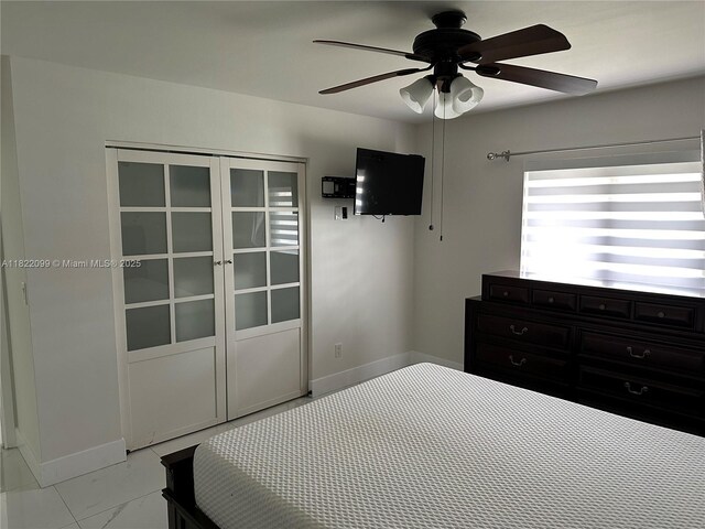 14944 SW 88th Ter, Miami, FL 33196 - unfurnished bedroom featuring light marble finish flooring and ceiling fan
