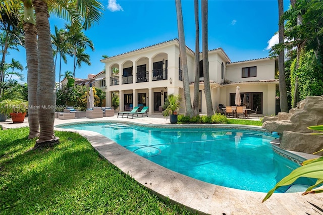 6535 Allison Rd, Miami Beach, FL 33141 - back of house featuring an outdoor hangout area, a balcony, a patio, and stucco siding