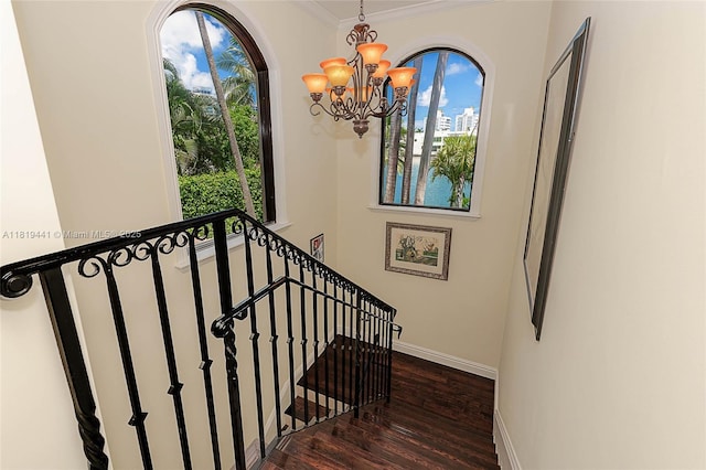 6535 Allison Rd, Miami Beach, FL 33141 - stairway with a chandelier, healthy amount of natural light, wood finished floors, and crown molding