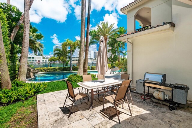 6535 Allison Rd, Miami Beach, FL 33141 - view of patio / terrace with outdoor dining space, an outdoor pool, and a water view