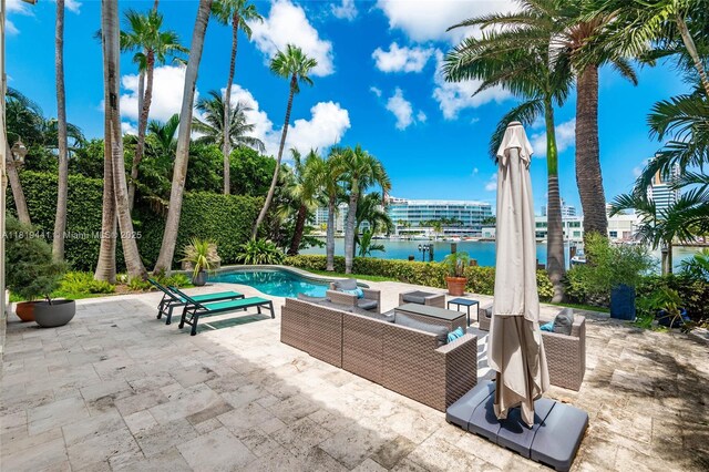 6535 Allison Rd, Miami Beach, FL 33141 - view of patio / terrace featuring a water view, an outdoor pool, and an outdoor living space