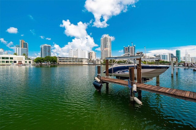 6535 Allison Rd, Miami Beach, FL 33141 - dock with boat lift, a water view, and a view of city