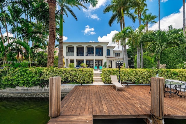 6535 Allison Rd, Miami Beach, FL 33141 - back of house featuring stucco siding, a balcony, and a tiled roof