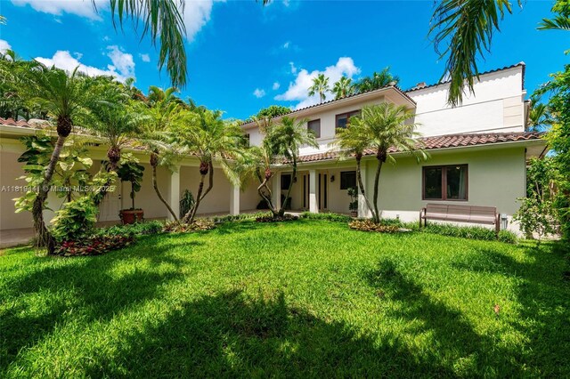 6535 Allison Rd, Miami Beach, FL 33141 - back of house featuring a lawn, stucco siding, and a tile roof