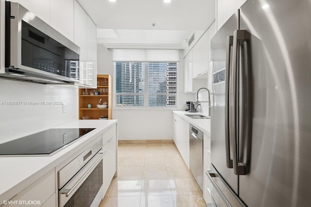 801 Brickell Key Blvd Unit 2202, Miami, FL 33131 - kitchen with stainless steel appliances, modern cabinets, white cabinets, light countertops, and recessed lighting
