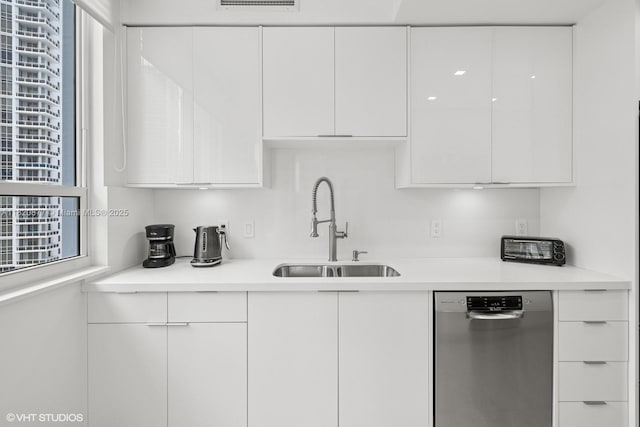 801 Brickell Key Blvd Unit 2202, Miami, FL 33131 - kitchen with stainless steel dishwasher, modern cabinets, white cabinets, and light countertops