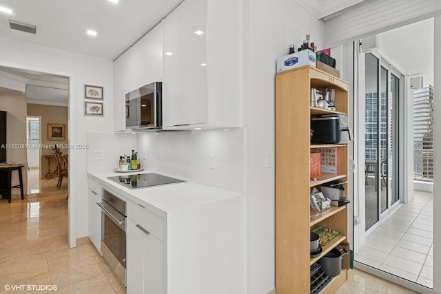 801 Brickell Key Blvd Unit 2202, Miami, FL 33131 - kitchen with appliances with stainless steel finishes, ornamental molding, modern cabinets, white cabinets, and open shelves