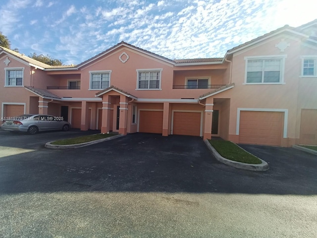 503 Belmont Ln Unit 503, North Lauderdale, FL 33068 - multi unit property featuring a garage, driveway, stucco siding, and a tiled roof