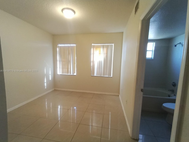 503 Belmont Ln Unit 503, North Lauderdale, FL 33068 - tiled empty room with baseboards and a textured ceiling